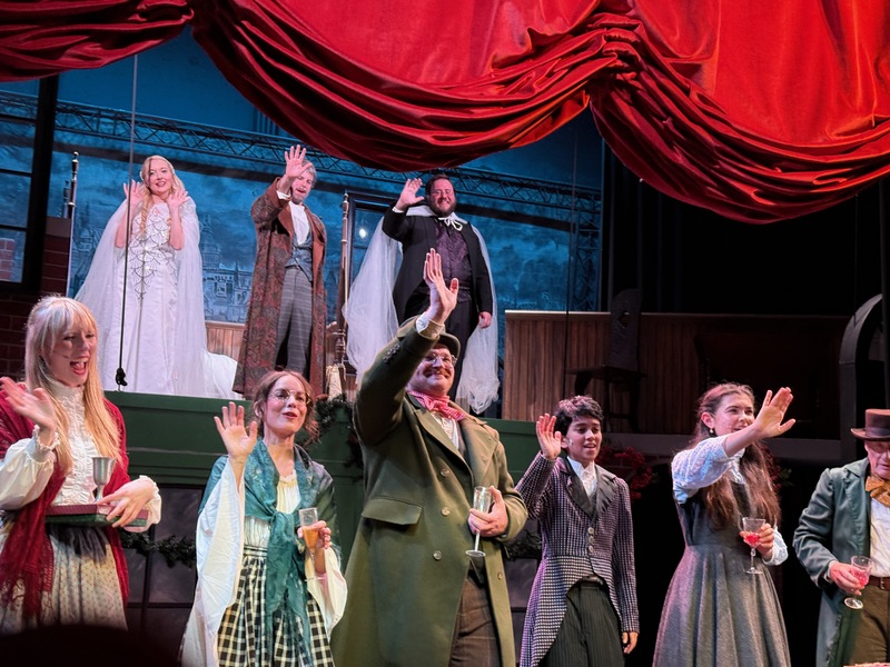 The cast waving during curtain call